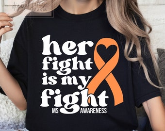 May include: Black crew neck sweatshirt with the text "her fight is my fight" in white, with an orange awareness ribbon. The words "MS Awareness" are at the bottom. The sweatshirt is a casual style.