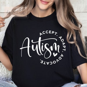 May include: Black t-shirt with white text that reads "Autism: Accept. Adapt. Advocate." with a small heart symbol.