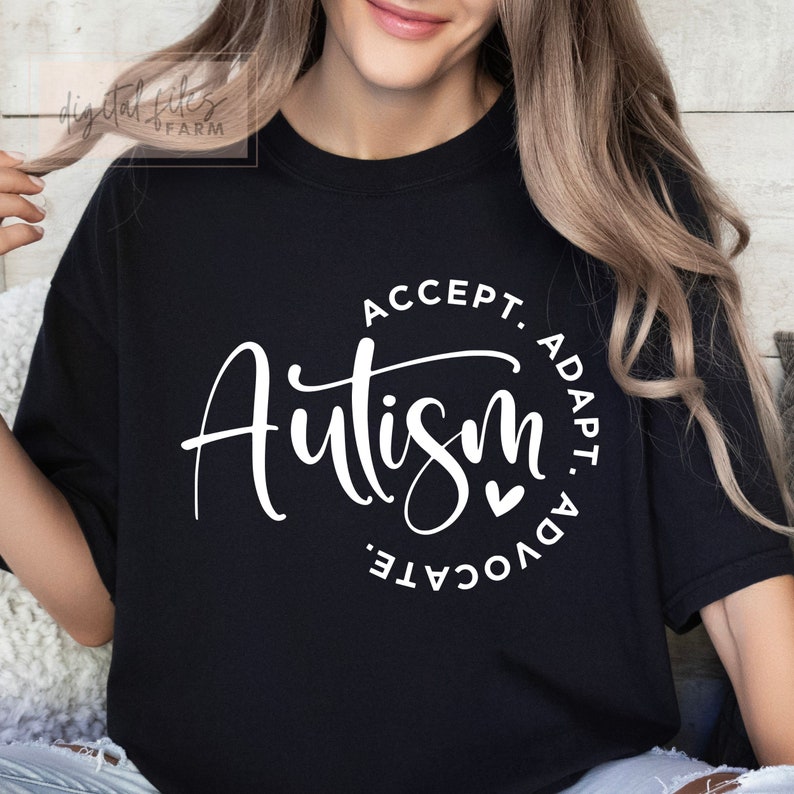 May include: Black t-shirt with white text that reads "Autism: Accept. Adapt. Advocate." with a small heart symbol.