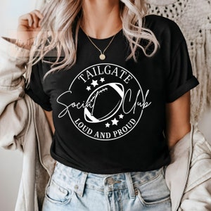 May include: Black t-shirt with a white circle graphic that says "Tailgate Social Club Loud and Proud" with a football inside the circle.