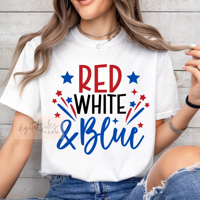 May include: White t-shirt with red, white, and blue text that says "Red White & Blue" with red and blue stars and fireworks.