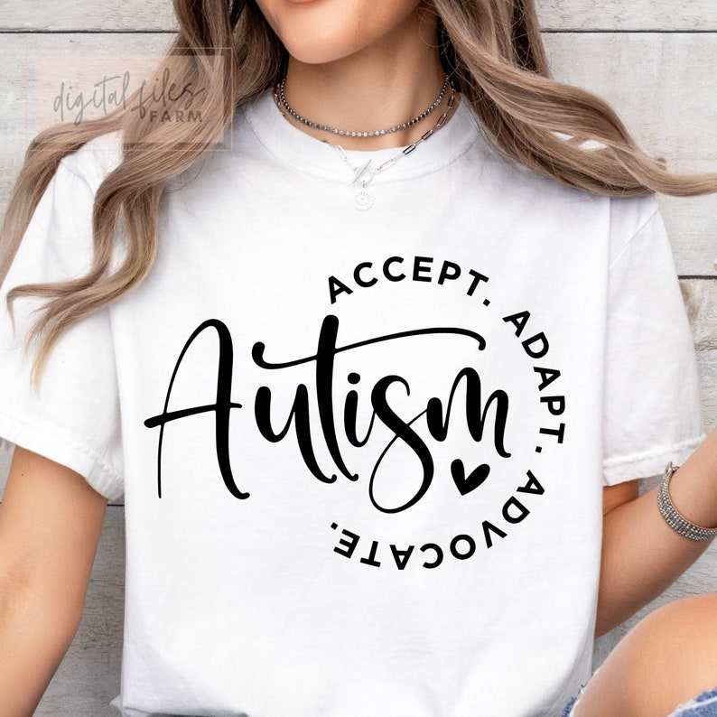 May include: White t-shirt with a black circle design that says "Accept. Autism. Adapt. Advocate." with a small heart in the center.