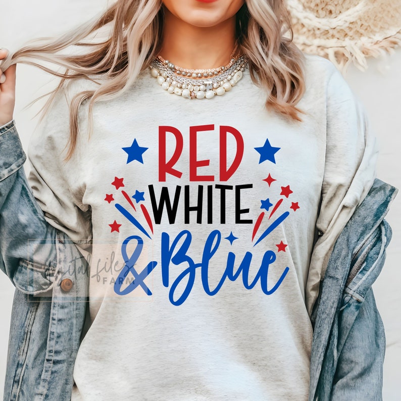 May include: A gray t-shirt with the text "Red White & Blue" in red, white, and blue lettering. The text is surrounded by red and blue stars.
