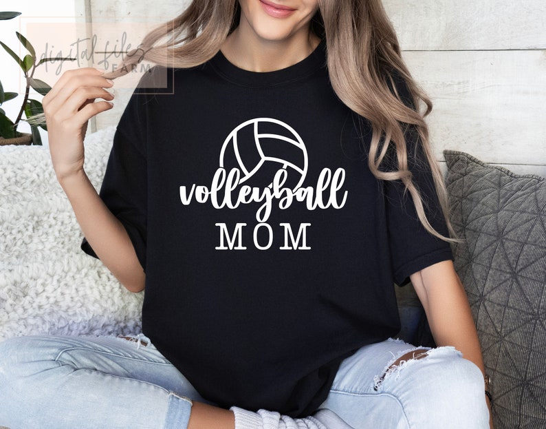 May include: Black t-shirt with a white volleyball graphic and the text "volleyball MOM" printed on the front.