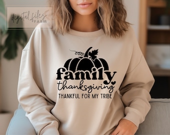 May include: A beige sweatshirt with a black graphic of a pumpkin and the text "family thanksgiving thankful for my tribe".