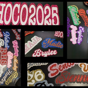 May include: Glittery foam cutouts with various names, words, and phrases. Includes "HOCO 2025", "Senior", "Homecoming", and names like "Madie" and "Brylee". The cutouts are in various colors, including pink, blue, and gold.