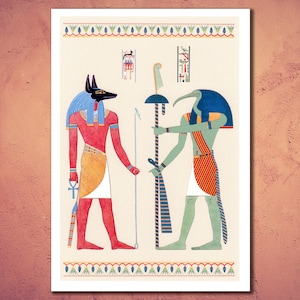 May include: An illustration of two Egyptian gods, Anubis and Thoth, standing side by side. Anubis is depicted as a jackal-headed man with a red body, a blue headdress, and a gold kilt. Thoth is depicted as a man with the head of an ibis, a green body, a blue headdress, and a red and white kilt. Both gods are holding staffs.