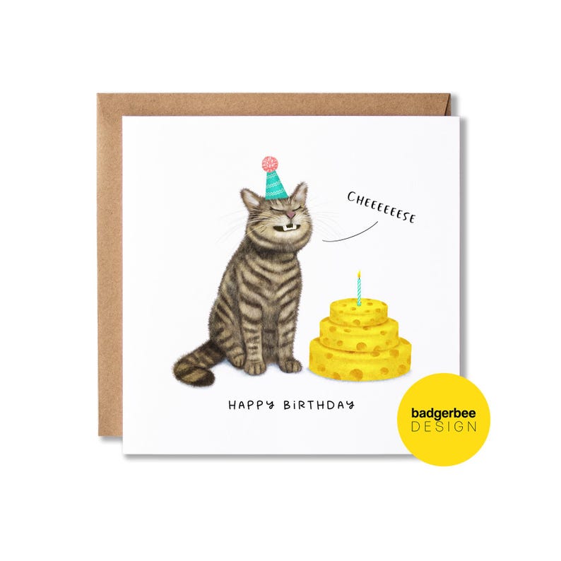 May include: A birthday card with a cartoon cat wearing a party hat, a three-tiered yellow cake with a lit candle, and the words "Cheeeeeese". The words "Happy Birthday" are written below the cat.