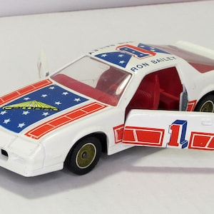Chevrolet Camaro Solido 12.84, France. Vintage collectible toy car. scale diecast model 1:43. American white car replica. doors open