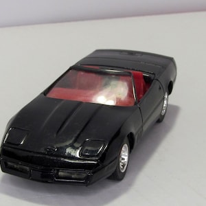 Chevrolet Corvette Solido 04-89, France. Vintage collectible toy car scale diecast model 1:43. American car replica. Miniature black car.