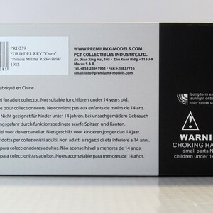 May include: A white box with black text and a barcode. The box is for a 1/43 scale model of a Ford Del Rey police car. The text on the box reads "PRD239 Ford Del Rey "Ouro" "Policia Militar Rodovi&aacute;ria" 1982". The box also includes a warning about choking hazards for children under 14 years old.