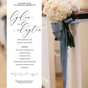 May include: A white and light pink floral bouquet with a light blue ribbon tied around it. The bouquet is placed on a white pew with a sign that reads "Welcome to the vow renewal ceremony of Lydia and Clayton. Sunday, January 16, 2022. Charlotte, North Carolina. Ceremony: Processional "Amazing Grace." Pastoral Greeting. Exchange of Vows. Exchange of Rings. Pronouncement of Renewed Marriage. Presentation of Bride & Groom. Recessional. Thank you for your love and support. Please join us at the reception following the ceremony."