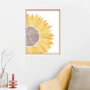 Puede incluir: Una impresi&oacute;n enmarcada de un girasol amarillo con centro marr&oacute;n, la flor est&aacute; orientada hacia la derecha y solo la mitad de la flor es visible en la imagen.