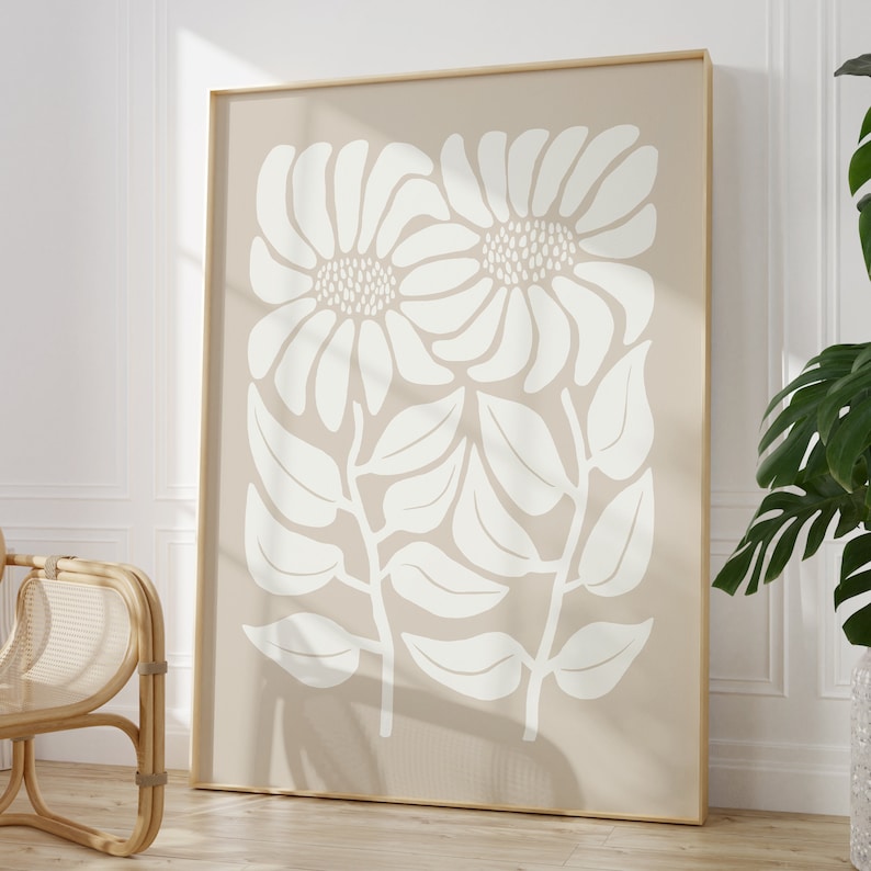 May include: A beige canvas print with a white floral design. The design features two large stylized flowers with leaves and stems.