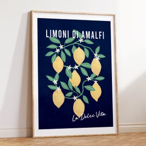 May include: A navy blue poster with a white border featuring a stylized illustration of a lemon tree with yellow lemons and white flowers. The text "Limoni di Amalfi" and "La Dolce Vita" is printed in white on the poster.