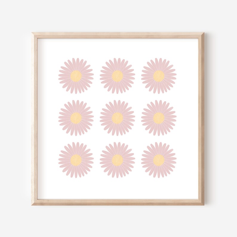 May include: A framed print with a pattern of nine pink and yellow daisies on a white background.