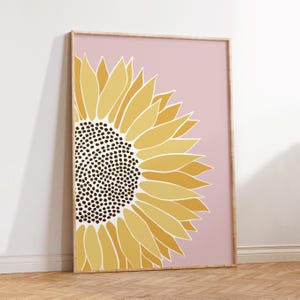 May include: A large, stylized sunflower with yellow and gold petals on a pink background. The sunflower is facing the right side of the image.