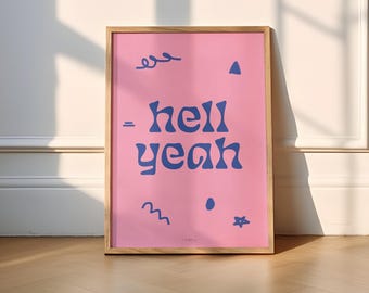 May include: A pink framed poster with the text "hell yeah" in blue lettering. The poster has a variety of abstract shapes and lines in blue.