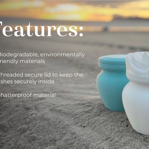 May include: Two biodegradable cremation urns, one blue and one white, with threaded lids. The urns are on a sandy beach with the text "Features:" above them. The text below the urns reads "Biodegradable, environmentally friendly materials", "Threaded secure lid to keep the ashes securely inside", and "Shatterproof material".