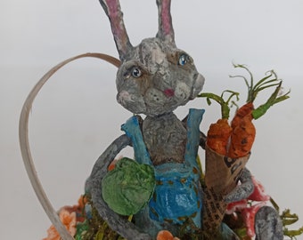 Spun cotton Easter bunny in the basket with flowers and Easter eggs