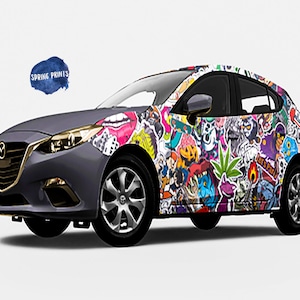 May include: A gray car covered in colorful stickers. The stickers feature various designs, including cartoon characters, animals, and abstract patterns. The car has a black bumper and black wheels.