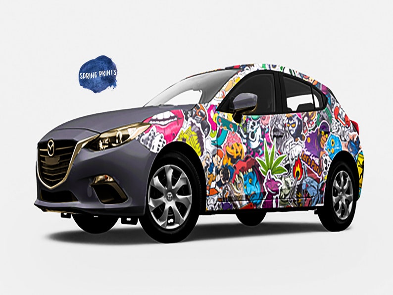 May include: A gray car covered in colorful stickers. The stickers feature various designs, including cartoon characters, animals, and abstract patterns. The car has a black bumper and black wheels.