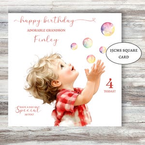 May include: A square birthday card featuring a child reaching for bubbles. The card includes the text "Happy Birthday, Adorable Grandson Finley" and "Have a day as special as you!" The card is 15cm square.