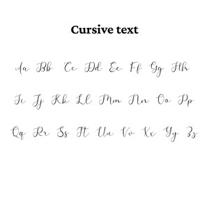 May include: A black and white graphic display featuring the words Cursive text at the top, followed by the complete English alphabet in both uppercase and lowercase letters, presented in a flowing, decorative script font style on a plain background.