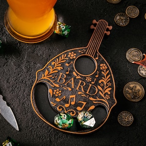 May include: A wooden bottle opener in the shape of a lute, featuring the word "BARD" and musical notes. The opener is adorned with floral designs and holds two green dice. A glass of amber liquid, coins, and a small dragon figurine are also visible.