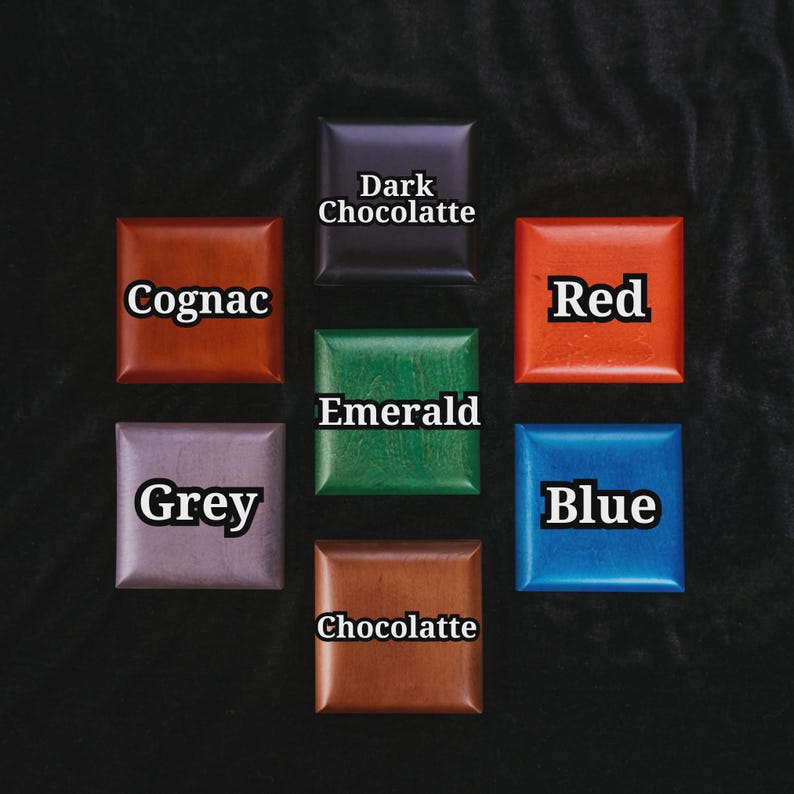 May include: Seven square blocks in a circular arrangement, each displaying a different color: Cognac, Dark Chocolatte, Red, Blue, Emerald, Grey, and Chocolatte. The colors are displayed on a dark background.