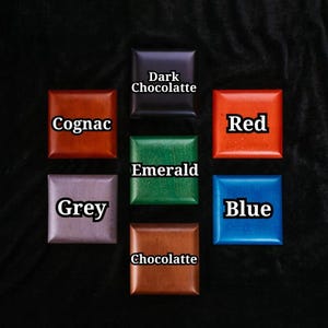 May include: A collection of square objects in various colors, including cognac, dark chocolate, red, emerald, grey, chocolate, and blue. Each square has a different color name written in white text.
