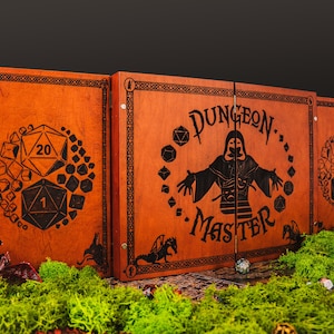 May include: A three-panel wooden dungeon master screen with a stained orange finish. The center panel features a hooded figure and the text "DUNGEON MASTER" surrounded by dice icons. The side panels display large twenty-sided dice with numbers 1 and 20.