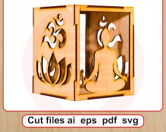 Peut inclure: Un cube décoratif en bois avec des motifs découpés. Un côté présente le symbole Om au-dessus d'une fleur de lotus, et un autre représente une figure méditative. Le texte "Cut files ai eps pdf svg" est en bas.