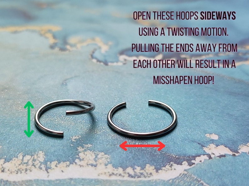 May include: Two silver hoop earrings on a blue background. The text on the image reads: "OPEN THESE HOOPS SIDEWAYS USING A TWISTING MOTION. PULLING THE ENDS AWAY FROM EACH OTHER WILL RESULT IN A MISSHAPEN HOOP!"