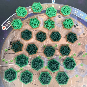 May include: A close-up view of a game board with green hexagonal game pieces. The board features a map of Mars with various locations labeled, including Pavonis Mons, Ascraeus, and Candor.