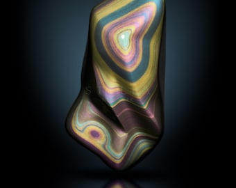 May include: A polished, abstract gemstone with a swirling pattern of colors including yellow, teal, purple, and brown. The stone has a smooth, reflective surface and the word "STELLA" is displayed at the bottom.