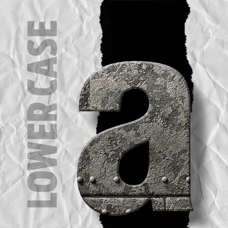 May include: A lowercase letter "a" made of metal with a rough, textured surface. The letter is in a distressed, industrial style with rivets and a worn appearance.