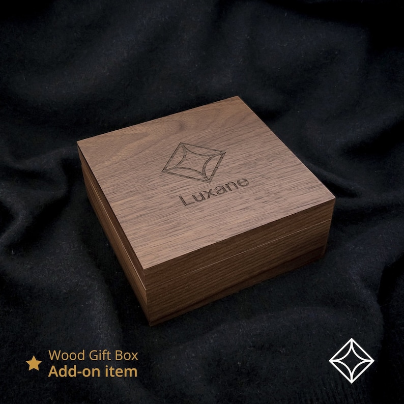 May include: A wooden gift box with a geometric design and the word "Luxane" engraved on the top. The box is made of dark brown wood and has a natural finish.