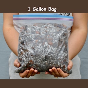 May include: A clear plastic bag filled with a mixture of brown and white soil. The bag is labeled "1 Gallon Bag".