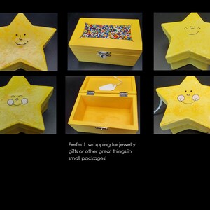 May include: Yellow star-shaped wooden box with a smiling face painted on the lid. The box is open and shows the inside is empty. Ideal for storing small items.