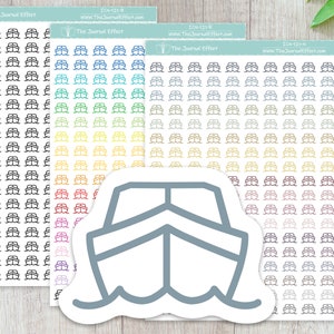 May include: A sheet of stickers with a variety of colored boat icons. The stickers are arranged in rows and columns. The boat icons are all the same size and shape, but they are different colors. The sheet of stickers is on a wooden surface.
