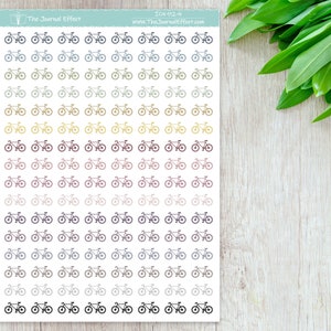 May include: A sheet of 60 small, black and white bicycle stickers. The stickers are arranged in 6 rows of 10. The stickers are in a gradient of colors, starting with light blue and ending with dark brown.