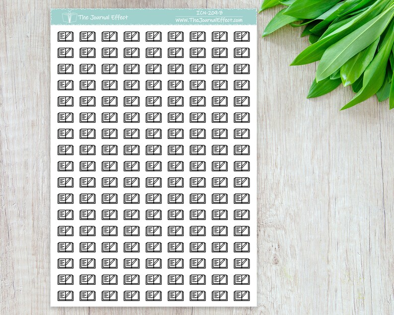 May include: A sheet of 100 black and white planner stickers featuring an open book with a pencil icon. The stickers are designed for use in a planner or journal.