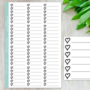 May include: A printable sheet of heart-shaped stickers with lines for writing. The sheet has 3 columns of hearts with 30 hearts total. The sheet is printed on white paper with black ink. The sheet is labeled "The Journal Effect" and has a website address.