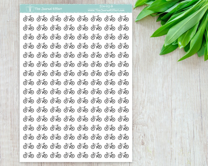 May include: A sheet of 100 black and white bicycle stickers. The stickers are arranged in a grid pattern. The text "The Journal Effect" and "www.TheJournalEffect.com" is printed at the top of the sheet.