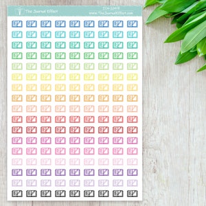 May include: A sheet of colorful stickers with an open book icon. The stickers are arranged in rows of 7, with each row featuring a different color. The colors are blue, green, yellow, orange, red, pink, purple, and black.