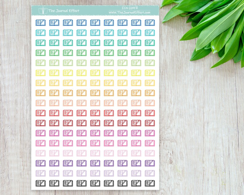 May include: A sheet of colorful stickers with an open book icon. The stickers are arranged in rows of 7, with each row featuring a different color. The colors are blue, green, yellow, orange, red, pink, purple, and black.