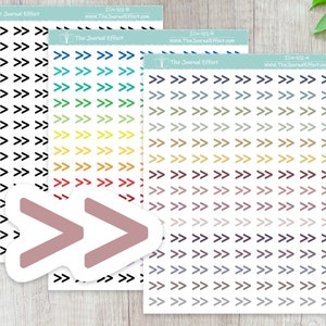 May include: Three sheets of stickers with various colored arrows pointing to the right. The stickers are on a light wood surface. The text on the stickers reads "The Journal Effect" and includes the website address and product code.