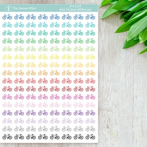 May include: A sheet of rainbow colored bicycle stickers. The stickers are arranged in rows of 6, with each row featuring a different color. The colors are blue, teal, green, yellow, orange, red, pink, purple, gray, and black. The stickers are all the same size and shape, and they feature a simple outline of a bicycle.