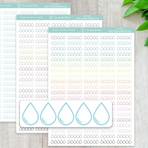 May include: Three sheets of adhesive planner stickers featuring rows of small water drop outlines in various colors, including blue, black, and a rainbow gradient. A separate rectangular strip shows five larger light blue water drop icons.